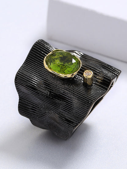 Enigmatic black Ring with Mesmerizing Green Gemstone